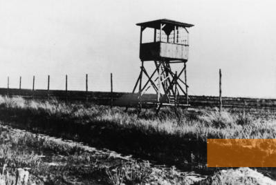 Image: Westerbork, undated, Barbed wire and one of the camp's seven watchtowers, Herinneringscentrum Kamp Westerbork/NIOD