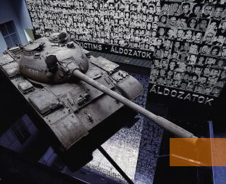 Bild:Budapest, o.D., Sowjetischer Panzer des Typs T-54 vor einer Wand mit Portraits von Opfern, Terror Háza