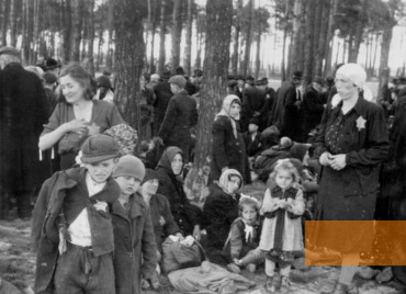 Image: Auschwitz-Birkenau, 1944, A family from Mukacheve – the standing girl Gerty Ackerman among them – shorly before being murdered in the gas chambers, Yad Vashem